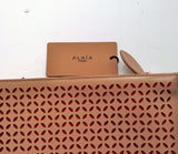 Alaia Arabesque Leather Laser Cutout clutch bag in beige nude and red purse